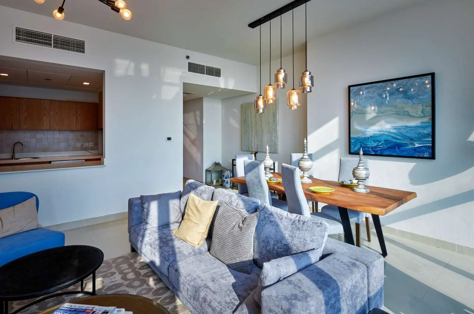 Contemporary dining area at Julphar Residence with open-plan layout.
